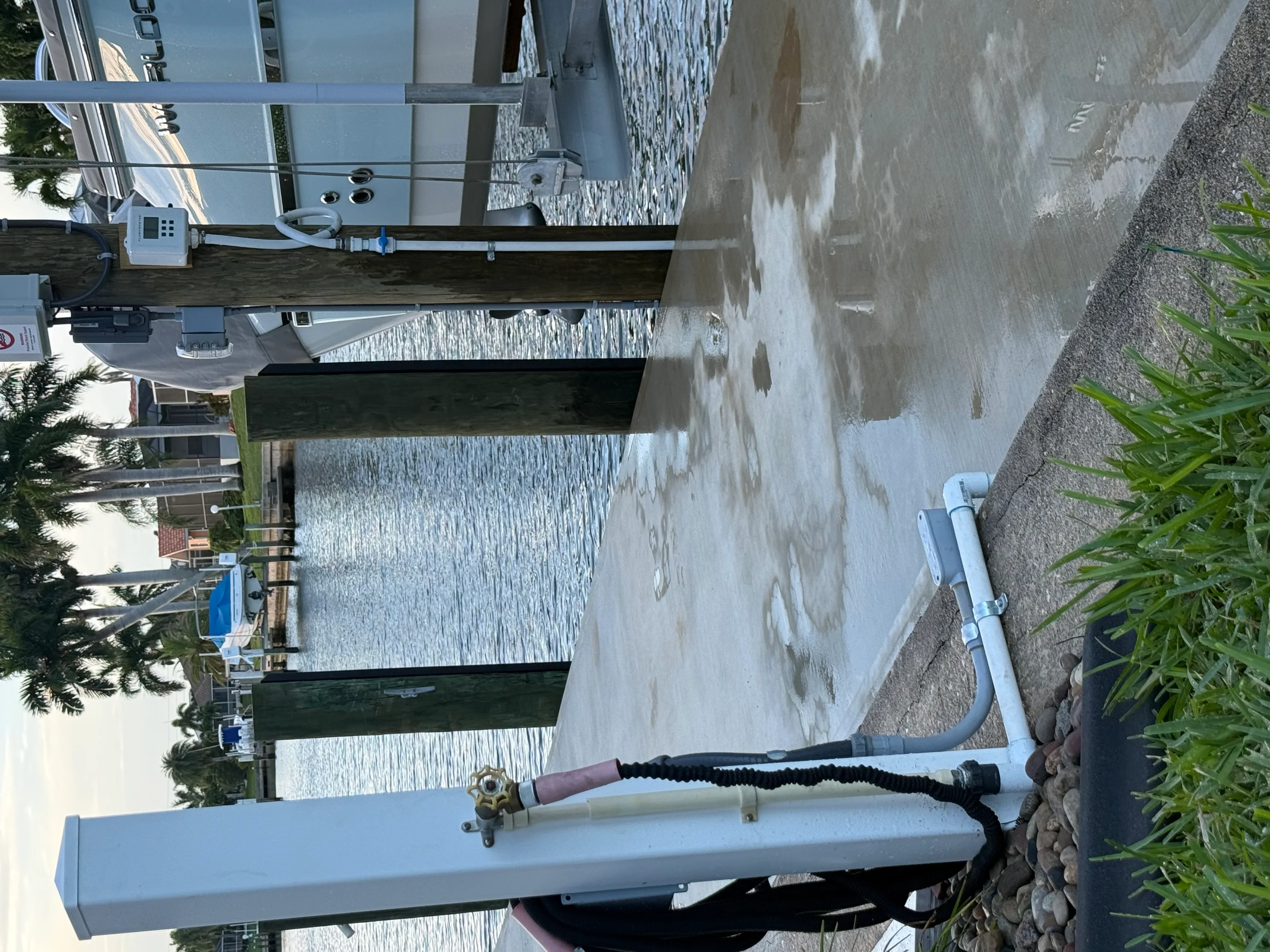 Installed water line with PVC piping, brass valve, and pressure gauge on residential property