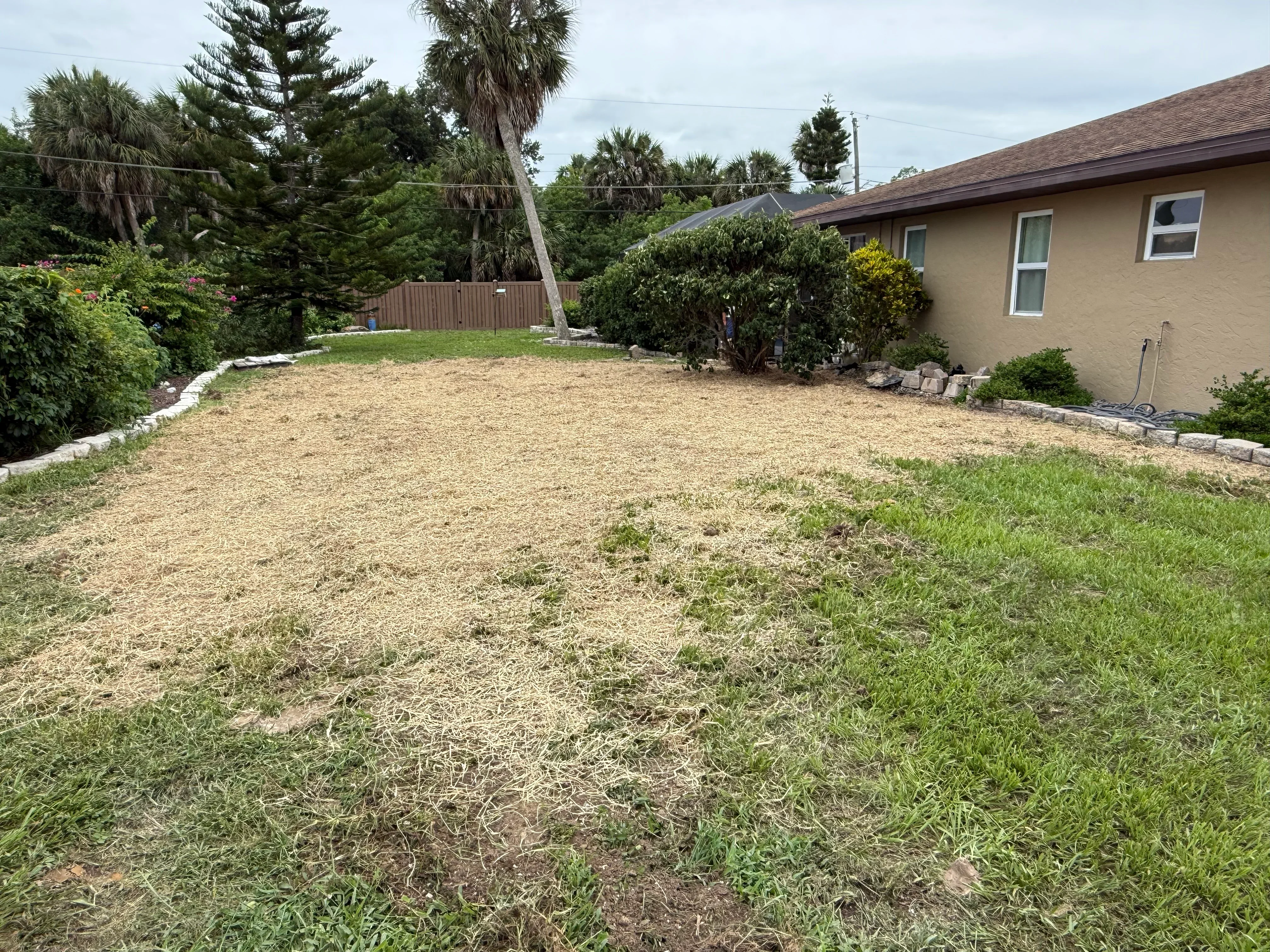 Residential septic system installation with excavated yard and white PVC piping in Punta Gorda