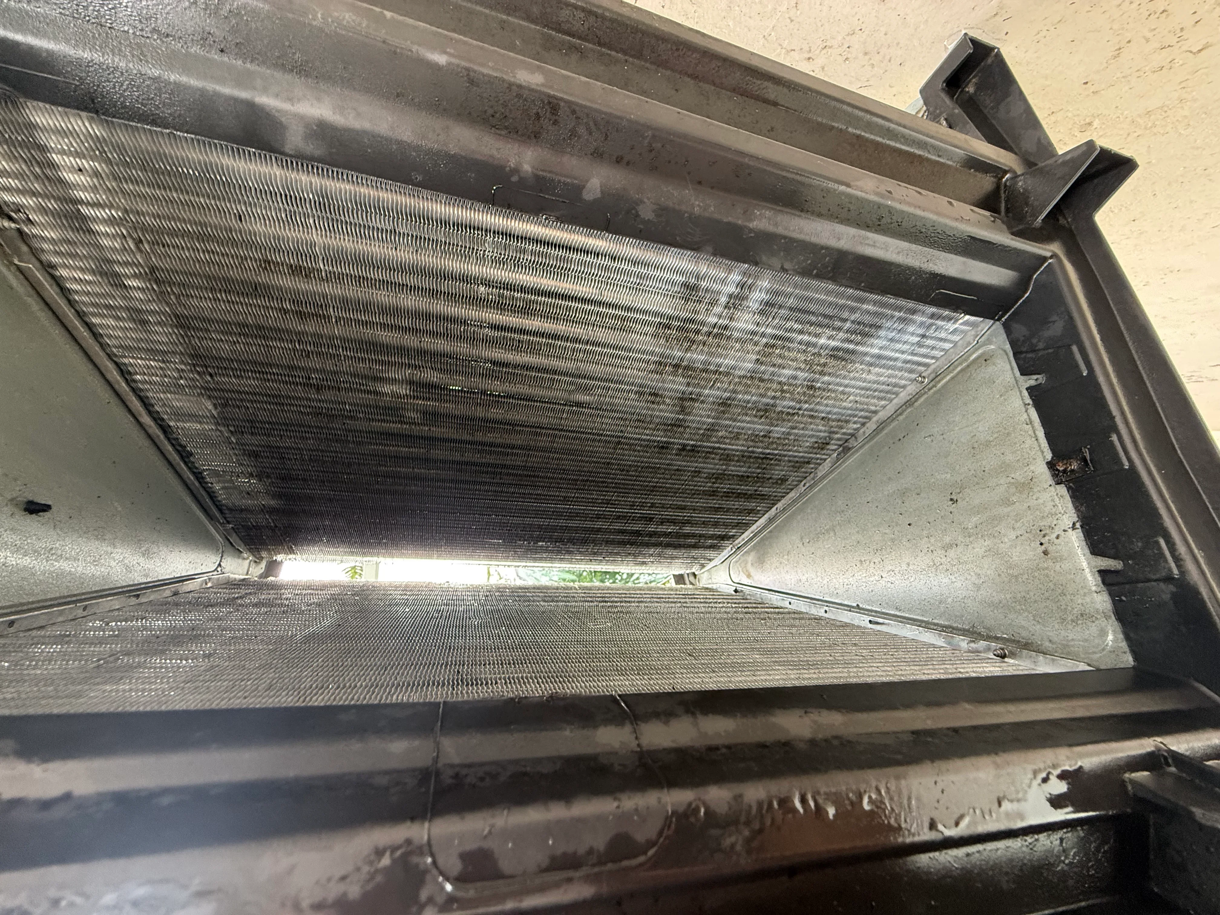 Close-up of cleaned AC condenser coil fins showing detailed aluminum fin structure