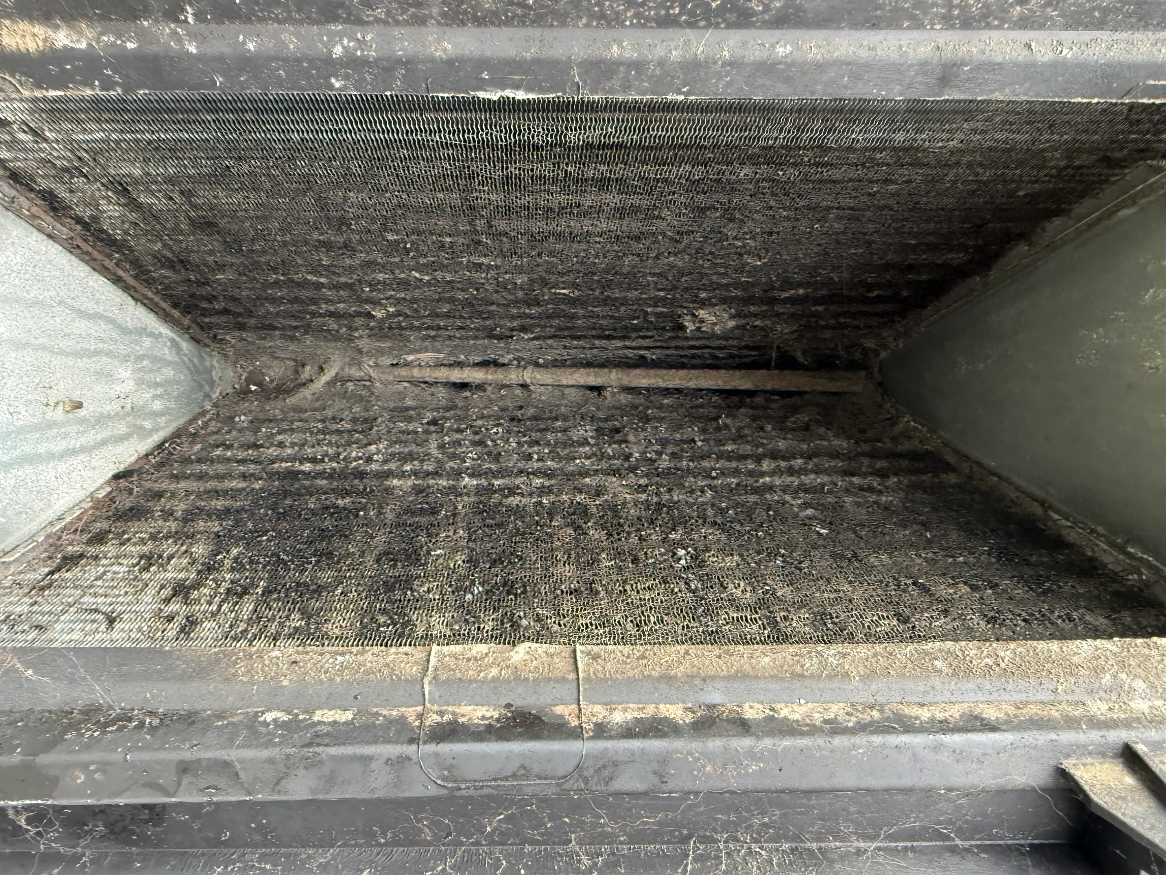 Clogged dryer vent duct filled with lint and debris requiring professional cleaning